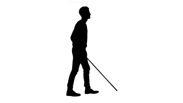 The image shows a black silhouette of a person in mid-step extending a cane forward, on a white background.